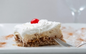 Creamy dessert slice with cherry topping