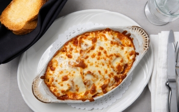 Lasagna noodles layered with meat sauce and topped with a blend of monterey jack, parmesan and mozza
